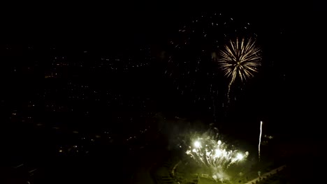 Aerial-shot-of-fireworks-with-city-lights-in-the-background