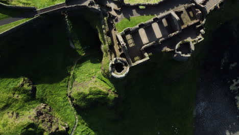 Turret-on-Ruins-of-Medieval-Dunluce-Castle-in-Ireland---Overhead-Aerial-Drone-Top-down-view