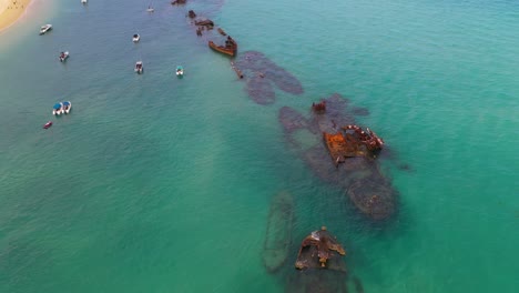 Amazing-Tangalooma-shipwrecks,-Moreton-Island-Australia,-aerial-view-over-boats