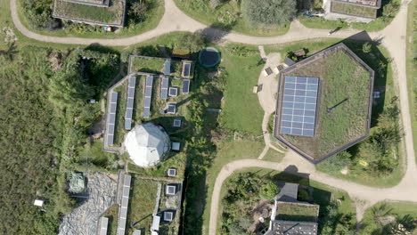 top-down-aerial-of-solar-panels-on-rooftops-on-beautiful-earthship-homes