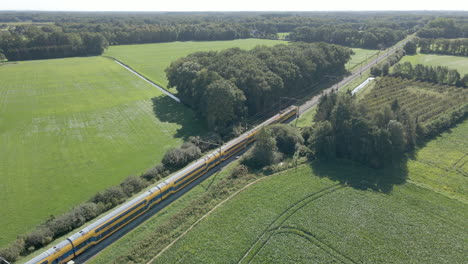 Aerial-of-train-driving-through-beautiful-Dutch-countryside