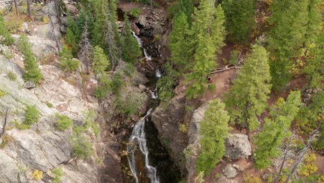 Aerial-drone-footage-moving-down-Fish-Creek-falls-in-Steamboat-Springs,-Colorado