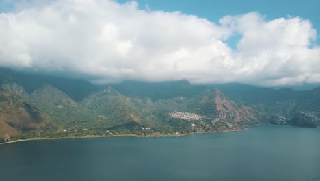 Drone-aerial-view-of-beautiful-lake-atitlan-during-sunny-day-in-Guatemala