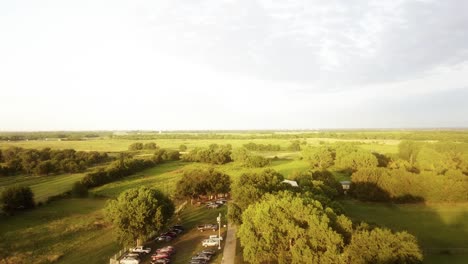 Aerial-over-a-parking-lot-at-a-converted-barn-wedding-venue-in-the-middle-of-Kansas-farmland