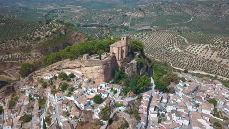 Aerial-view-of-the-church-in-top-of-the-big-rock-over-Montefrio-in-Granada,-Andalusia