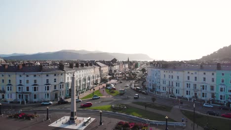 Aerial-view-of-pretty-terrace-buildings-on-Llandudno-promenade-with-mountains-in-the-background