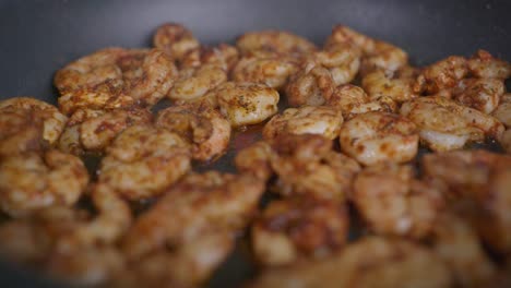 Extreme-close-up-of-seasoned-shrimp-frying-in-a-pan
