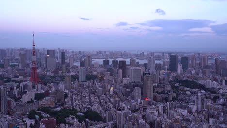Beautiful-panorama-view-out-on-Tokyo-cityscape-at-dusk-with-famous-Tokyo-Tower---locked-off-view