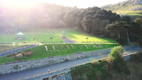 Drone-flight-over-the-grass-Llandudno-sign-in-the-Happy-Valley-Gardens