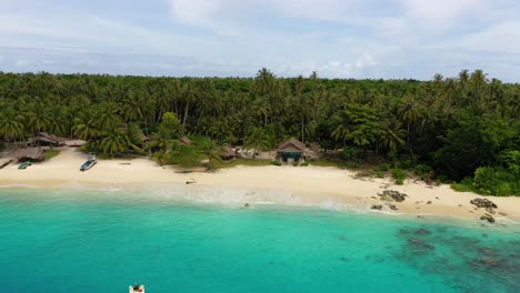 Aerial-view-of-beautiful-blue-water-and-sandy-beach-at-Asu-Island,-North-Sumatra,-Indonesia---drone-flying-towards-beach-house