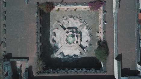 Drone-aerial-bird's-eye-view-of-a-beautiful-colonial-style-fountain-located-in-Antigua-Guatemala