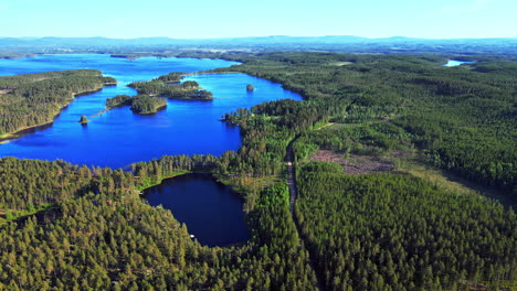 Lush-Green-Island-Landscape-Surrounded-By-Deep-Blue-Sea-In-Vansbro-Municipality,-Dalarna-County,-Sweden---Aerial-Shot