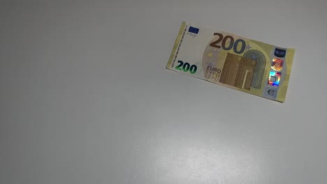 Flying-200-euros-banknote-on-a-white-background-in-slowmotion