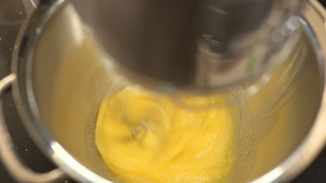 View-inside-a-stand-mixer-as-it-blends-sugar-and-eggs-for-baking-a-pastry