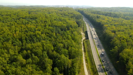 Aerial-reveal-shot-of-a-big-highway-through-a-forest-of-the-north-of-Poland