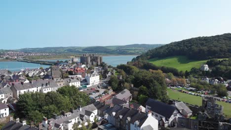Drone-flight-over-the-ruins-of-Conwy-castle-and-the-town-cottages,-Wales
