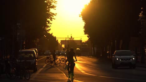 Cyclist-and-Cars-on-Almost-Empty-Street-of-Berlin-during-Golden-Hour