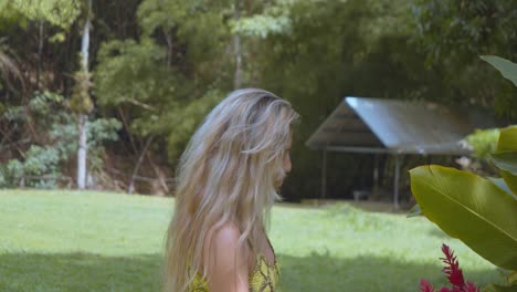 Blonde-hair-girl-admiring-a-flower-at-a-ranch-on-the-Caribbean-island-of-Trinidad