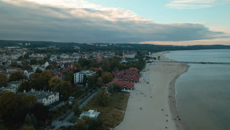 Aerial-view-with-seaside-resort-city-and-sandy-beach-at-the-shore-of-Baltic-Sea