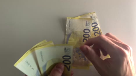 Close-up-of-male-hands-counting-euro-bills