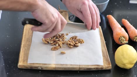 Close-up-chopping-walnuts-on-a-cutting-board