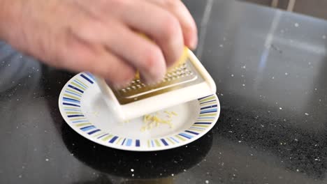 Close-up-of-using-a-grater-to-remove-lemon-zest
