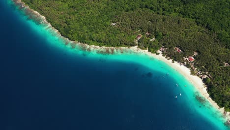 Aerial-view-of-blue-water-surrounding-Asu-Island,-North-Sumatra,-Indonesia-and-beach-on-the-island