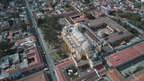 Drone-aerial-view-of-Antigua-Guatemala-colonial-colorful-town-with-beautiful-historical-church-La-Merced