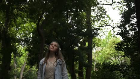 Young-Caucasian-female-walking-through-woodland-wilderness-thinking-concept-slow-motion