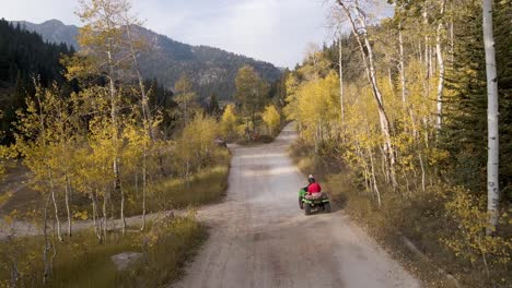 Drone-chasing-ATV-rider-through-forest-trail-Utah-Mountains-and-forest