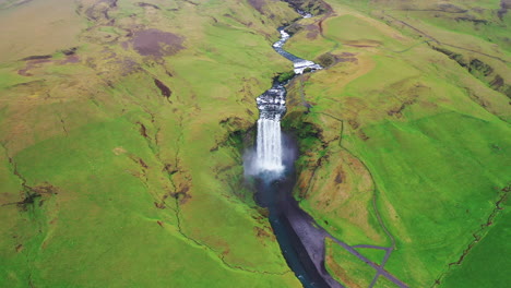 Skogafoss-waterfall-during-summer---Pullback-aerial-video---Ring-Road-Iceland-in-4k
