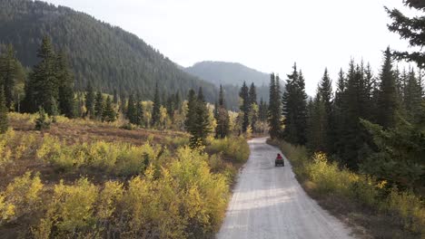 Drone-wide-shot-following-ATV-rider-towards-Utah-Wasatch-Mountains