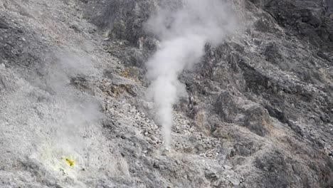 Sulfur-smoke-coming-out-of-rocks-in-volcano-in-North-Sumatra,-Indonesia