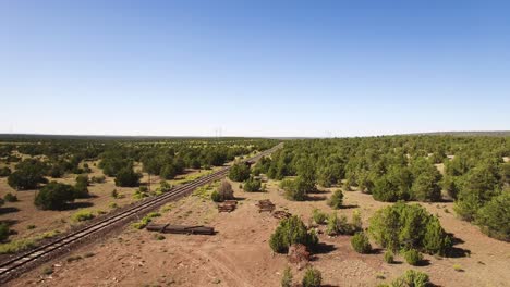 Aerial-descent-over-the-rail-line-and-supply-area,-Williams,-Arizona