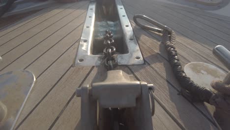 Close-up-of-the-anchor-chain-retracting-on-a-yacht