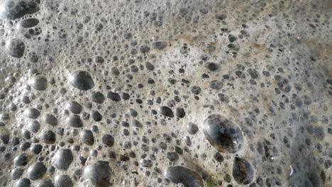 Close-up-of-foam-floating-on-water-surface