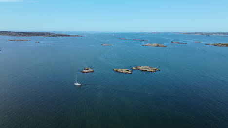 Sailing-between-the-small-islands-of-Långedrag,-Gothenburg,-Sweden---aerial