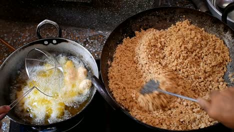 two-men-frying-food-in-oil-and-fry-stirring-in-a-pan