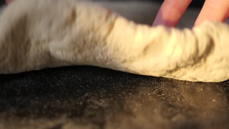 Unique-extreme-close-up-of-pizza-dough-being-rolled-out-towards-the-camera