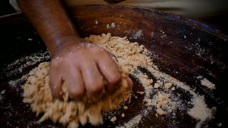 man-separating-dough-from-the-plate