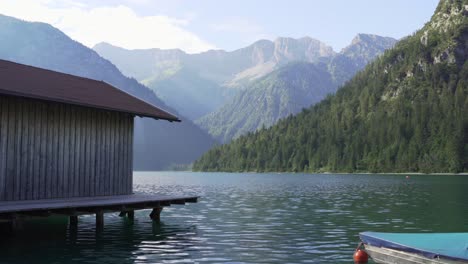 Fishermans's-house-at-lake-with-mountains-in-background