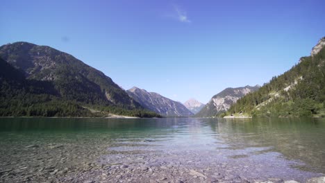 Scenic-view-of-Lake-Plansee-with-mountains-in-background,-Austria