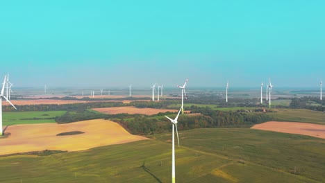 there-are-a-lot-of-rotating-windmills-in-the-shot,-drone-shot,-camera-zooms-in