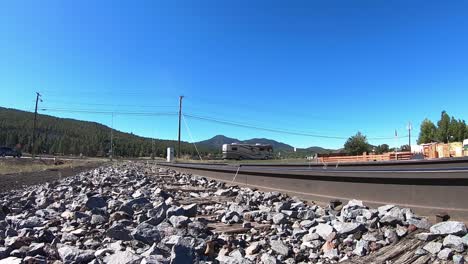 Low-angle-of-a-large-RV-crosses-the-railroad-tracks-in-Williams,-Arizona-vehicle