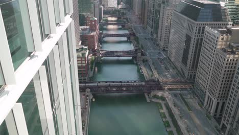 CTA-Trains-Cross-Bridge-over-Chicago-River,-High-Angle
