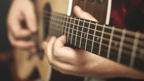 Close-up-of-a-western-acoustic-guitars-neck-and-strings-while-a-guitar-solo-is-being-played-on-it-by-a-professional-musician