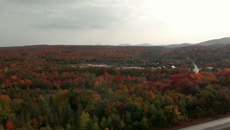 Aerial-Landscape-View-Of-Colored-Maple-Trees-And-Scenic-Countryside-Road-In-Eastern-Townships,-Quebec-During-Autumn---panning-drone-shot