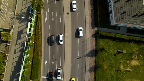 Aerial---following-moving-forward-cars-on-highway-road-near-Gdynia-Witomino-forest,-Poland