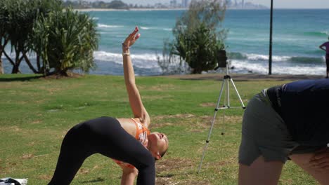 Yoga-Instructor-Doing-The-Preparation-To-Reversed-Triangle-Pose-In-Burleigh-Hill---Queensland,-Australia---full-slowmo-shot