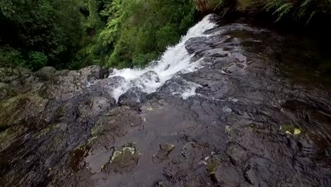 Aerial-of-Looking-down-a-Mountain-Waterfall-in-the-Green-Jungle